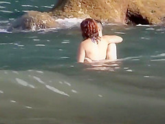 Stones on a naked beach woman