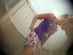 Chick takes off her green bikini and dresses
