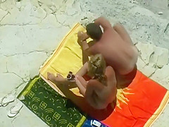 Horny blonde enjoys the beach