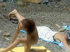 Nudist girl caught doing beach yoga