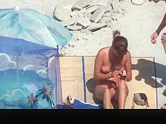 Nudist woman takes off her clothes