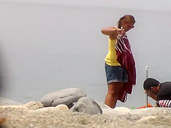 Chubby girl undresses at the beach