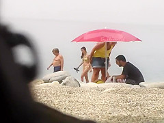 Chubby girl undresses at the beach