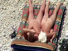 Nudist couple tanning and relaxing