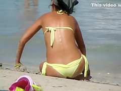 Sexy milf sitting at the beach