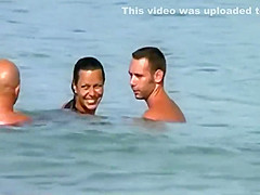 Swinging nudists spied on a beach