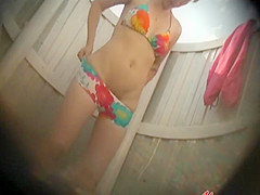 Shaved pussy under a colorful bikini
