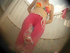 Shaved pussy under a colorful bikini