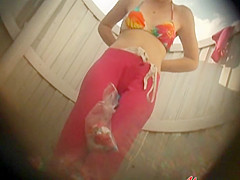 Shaved pussy under a colorful bikini