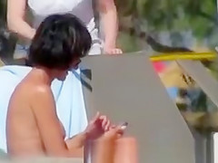 Short hair woman topless at beach