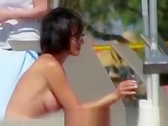Short hair woman topless at beach