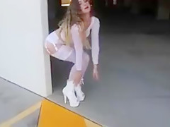 Sexy schoolgirl in white lingerie walks outside.