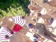 Young nudists take off their clothes to soak up some sun on