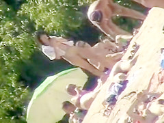 Young nudists take off their clothes to soak up some sun on