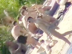 Young nudists take off their clothes to soak up some sun on