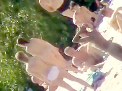 Young nudists take off their clothes to soak up some sun on