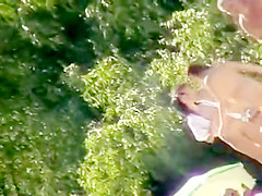 Young nudists take off their clothes to soak up some sun on