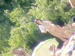 Young nudists take off their clothes to soak up some sun on