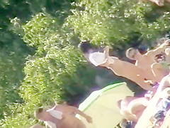 Young nudists take off their clothes to soak up some sun on