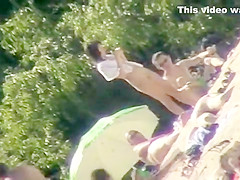 Young nudists take off their clothes to soak up some sun on