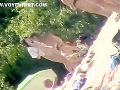 Young nudists take off their clothes to soak up some sun on