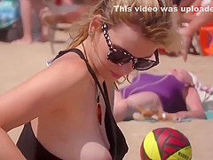 Fit topless blonde with hot natural tits on the beach !