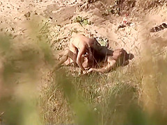 Voyeur on public beach. Hot young couple sex