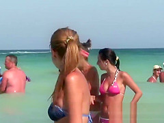 Young topless teens on the beach showing natural firm boobs in public!