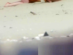 Chick on a nudist beach tanning and bending a nudist beach v