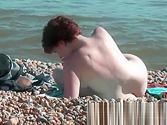 Chick on a nudist beach tanning and bending a nudist beach v