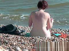 Chick on a nudist beach tanning and bending a nudist beach v