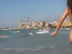 Amazing baby getting naked on the beach