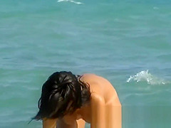 This beautiful nudist woman was sunbathing on a nude beach