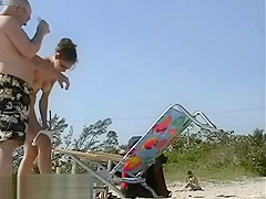 Dark haired nudist spied pissing on the beachvoyeur voyeur