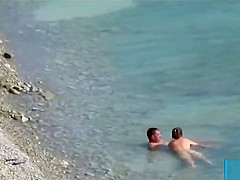 Couple fucked on a public beach while as people walked near