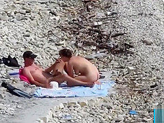 Couple fucked on a public beach while as people walked near
