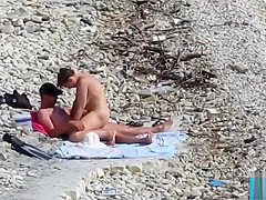 Couple fucked on a public beach while as people walked near