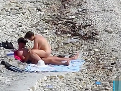Couple fucked on a public beach while as people walked near