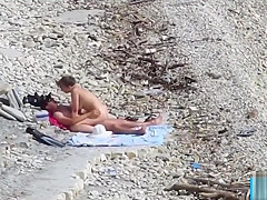 Couple fucked on a public beach while as people walked near