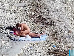 Couple fucked on a public beach while as people walked near
