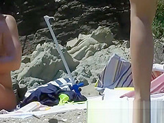 Some teen and mature couples resting at the nudist beach