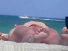 A nude beach voyeur films a funny girl