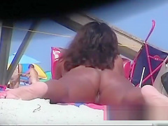 Naked hotties followed around by a nude beach voyeur