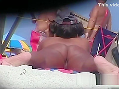 Naked hotties followed around by a nude beach voyeur