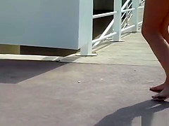 Naked spinner disgraced on the beach