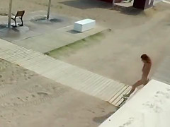 Naked spinner disgraced on the beach