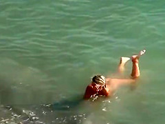 Nudist girls expose bodies at the beach