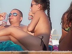 dark haired beach beauty topless