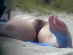 Busty girl shows her mighty jugs on a nudist beach