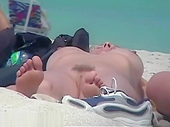 Busty girl shows her mighty jugs on a nudist beach